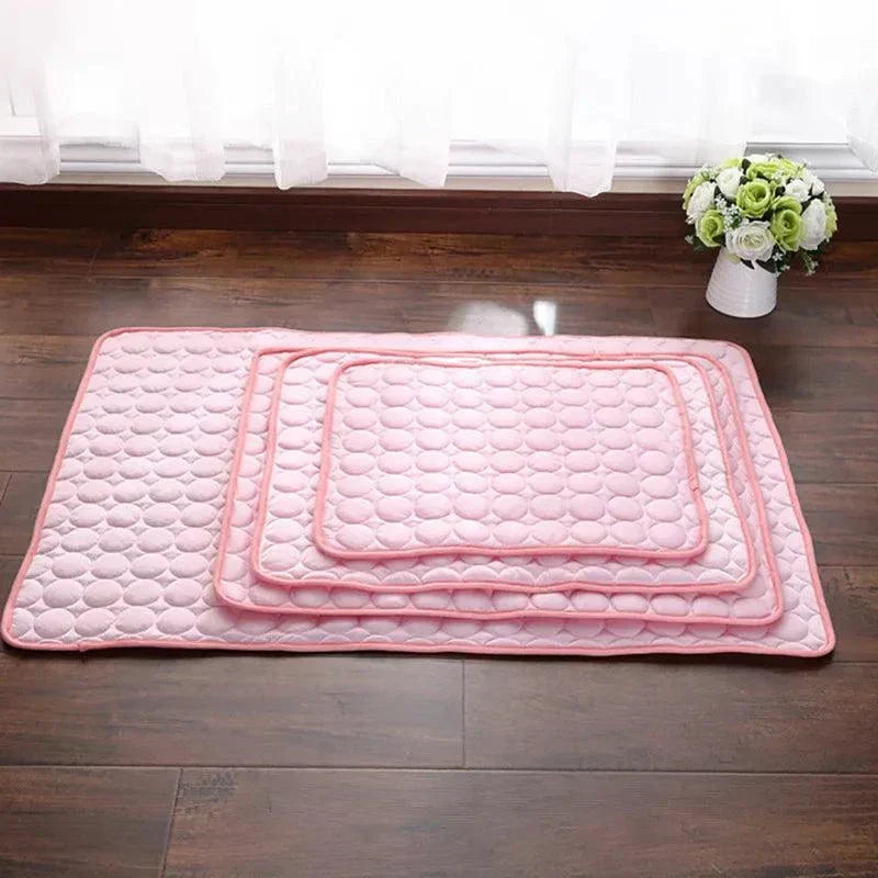 Pink dog mat cooling pad set for summer pet comfort on wooden floor
