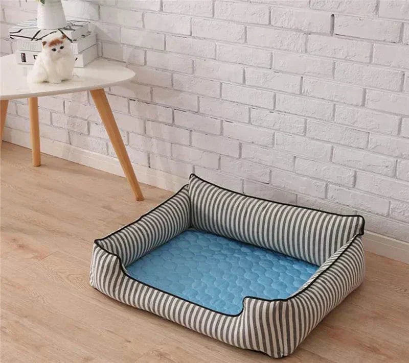 Cooling dog mat with blue padded center and striped cushioned sides for pet comfort